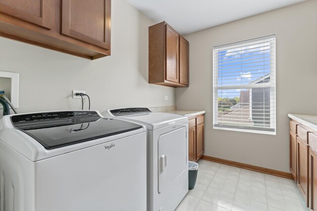 3816 Stockton Dr, Joliet, IL 60436 - laundry area featuring washer and dryer, cabinet space, and baseboards