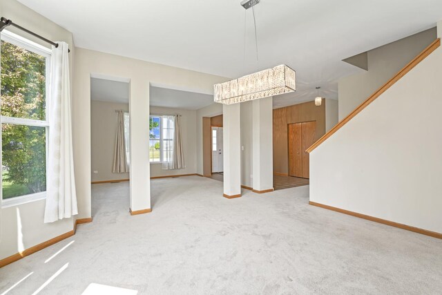 3816 Stockton Dr, Joliet, IL 60436 - unfurnished dining area with baseboards, light colored carpet, and stairway