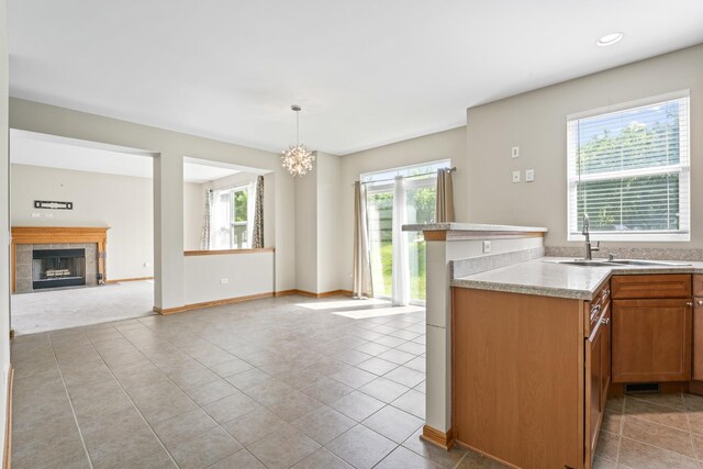 3816 Stockton Dr, Joliet, IL 60436 - kitchen with a sink, light countertops, light tile patterned floors, a tiled fireplace, and recessed lighting