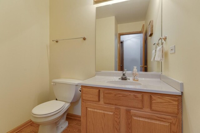 816 Adam Ln, Hampshire, IL 60140 - half bath with toilet, vanity, wood finished floors, and baseboards