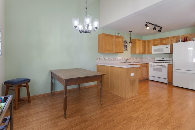 816 Adam Ln, Hampshire, IL 60140 - kitchen with white appliances, a sink, light countertops, a peninsula, and a chandelier