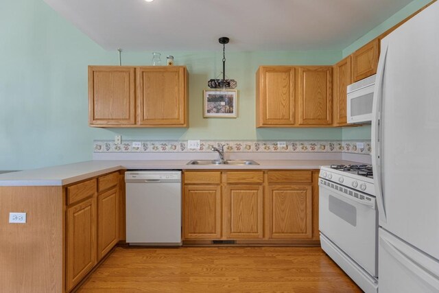 816 Adam Ln, Hampshire, IL 60140 - kitchen with white appliances, a sink, a peninsula, light countertops, and light wood-type flooring