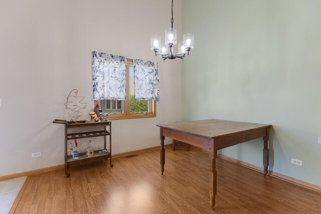 816 Adam Ln, Hampshire, IL 60140 - dining room with a chandelier, wood finished floors, and baseboards