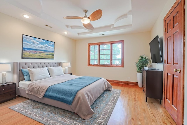 5352 N Neva Ave, Chicago, IL 60656 - bedroom featuring light wood finished floors, a tray ceiling, baseboards, recessed lighting, and a ceiling fan