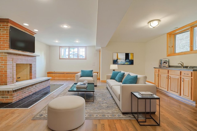 5352 N Neva Ave, Chicago, IL 60656 - living area featuring light wood-style floors, a fireplace, recessed lighting, and baseboards