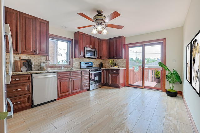 5352 N Neva Ave, Chicago, IL 60656 - kitchen with stainless steel appliances, tasteful backsplash, ceiling fan, light wood-type flooring, and light stone counters