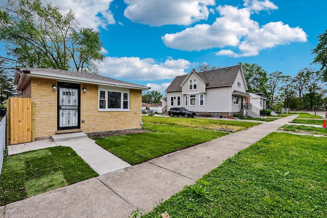 337 W 106th Pl, Chicago, IL 60628 - view of front of home featuring brick siding and a front yard