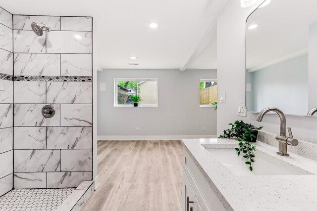 337 W 106th Pl, Chicago, IL 60628 - bathroom featuring a tile shower, double vanity, wood finished floors, recessed lighting, and baseboards
