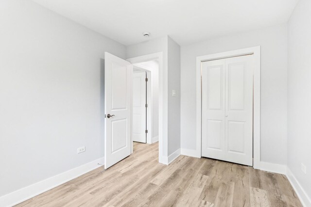 337 W 106th Pl, Chicago, IL 60628 - unfurnished bedroom featuring light wood-type flooring, baseboards, and a closet
