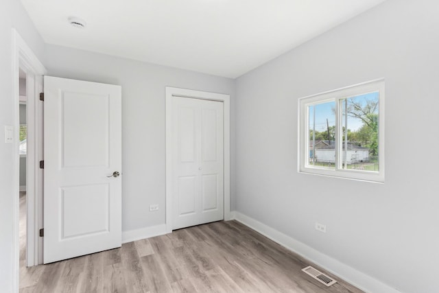 337 W 106th Pl, Chicago, IL 60628 - unfurnished bedroom with light wood-style flooring, a closet, and baseboards