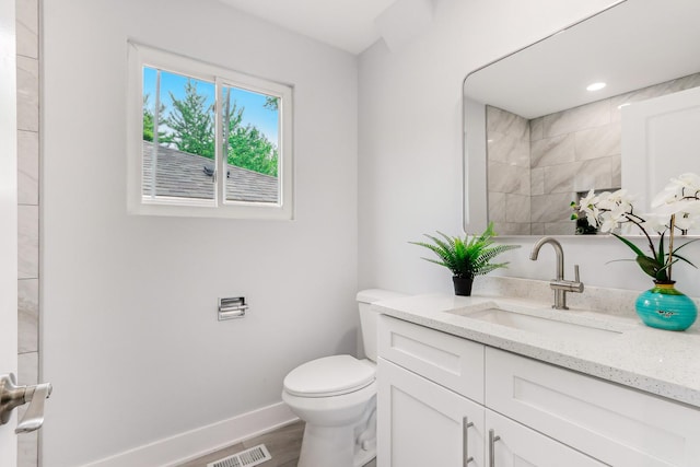 337 W 106th Pl, Chicago, IL 60628 - full bathroom with toilet, baseboards, vanity, and wood finished floors