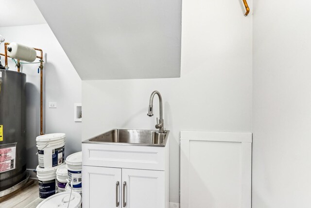 337 W 106th Pl, Chicago, IL 60628 - laundry area featuring water heater, washer hookup, and light wood finished floors