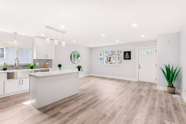 337 W 106th Pl, Chicago, IL 60628 - kitchen with a sink, light countertops, white cabinetry, light wood-style flooring, and recessed lighting