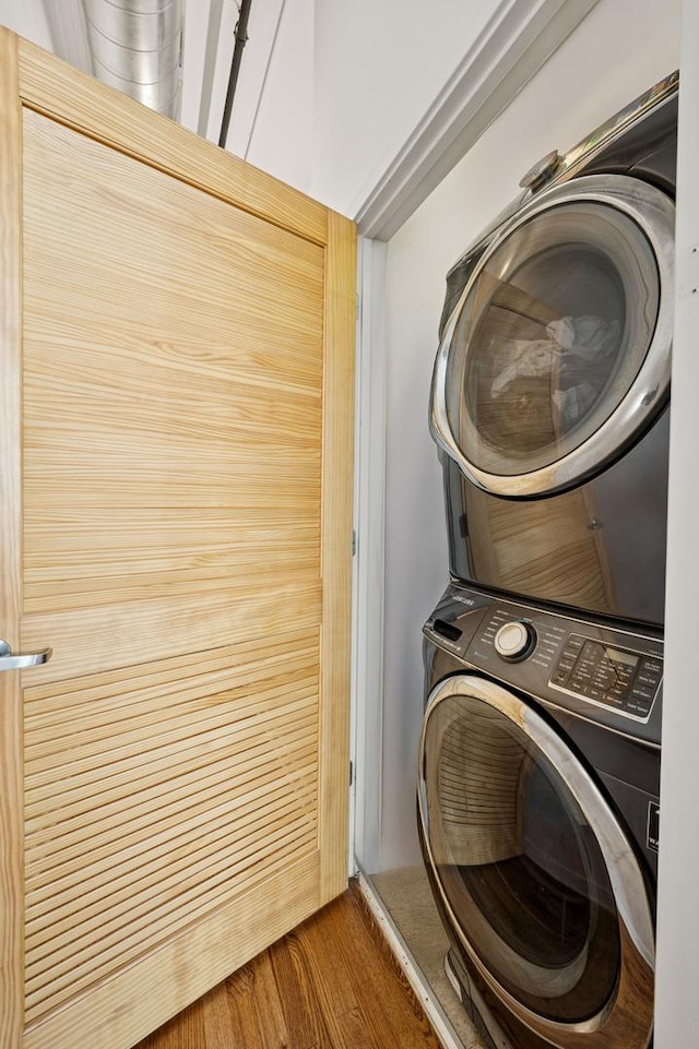 1224 W Van Buren Ave Unit 416, Chicago, IL 60607 - washroom featuring stacked washer / dryer and wood finished floors
