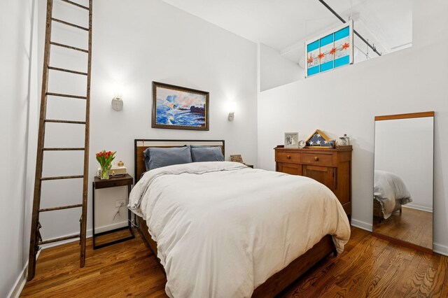 1224 W Van Buren Ave Unit 416, Chicago, IL 60607 - bedroom featuring wood finished floors, a high ceiling, and baseboards