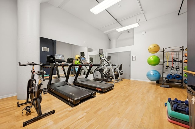 1224 W Van Buren Ave Unit 416, Chicago, IL 60607 - workout area featuring wood finished floors, high vaulted ceiling, and baseboards