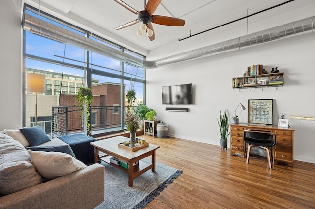1224 W Van Buren Ave Unit 416, Chicago, IL 60607 - living area featuring ceiling fan, wood finished floors, baseboards, and floor to ceiling windows
