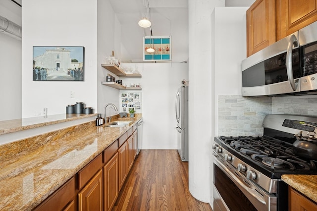 1224 W Van Buren Ave Unit 416, Chicago, IL 60607 - kitchen with appliances with stainless steel finishes, a sink, brown cabinets, wood finished floors, and light stone countertops