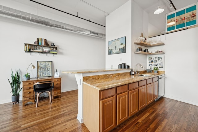1224 W Van Buren Ave Unit 416, Chicago, IL 60607 - kitchen with a sink, brown cabinets, light stone counters, wood finished floors, and a peninsula