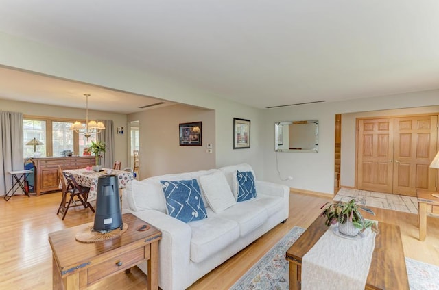 7930 Grant St, Darien, IL 60561 - living room with a chandelier, light wood-style floors, and baseboards