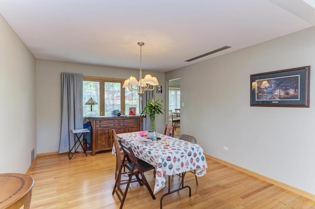 7930 Grant St, Darien, IL 60561 - dining space featuring a chandelier, light wood finished floors, healthy amount of natural light, and baseboards