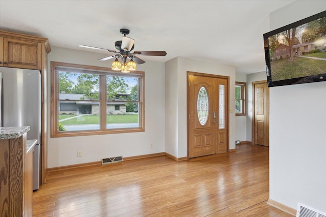 717 S Kennedy St, Shannon, IL 61078 - foyer entrance featuring a ceiling fan, light wood-style flooring, and baseboards