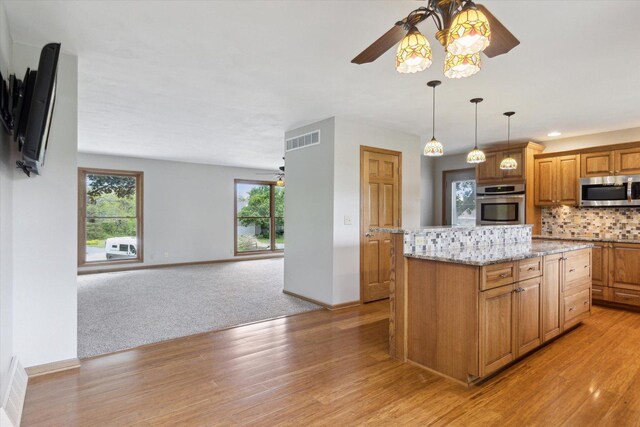 717 S Kennedy St, Shannon, IL 61078 - kitchen with stainless steel appliances, a ceiling fan, light wood-style floors, backsplash, and baseboards