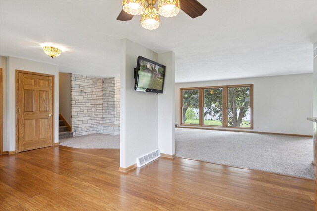 717 S Kennedy St, Shannon, IL 61078 - carpeted spare room featuring ceiling fan, stairs, baseboards, and wood finished floors