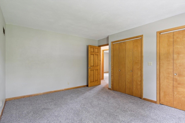 717 S Kennedy St, Shannon, IL 61078 - unfurnished bedroom with carpet flooring, baseboards, and multiple closets