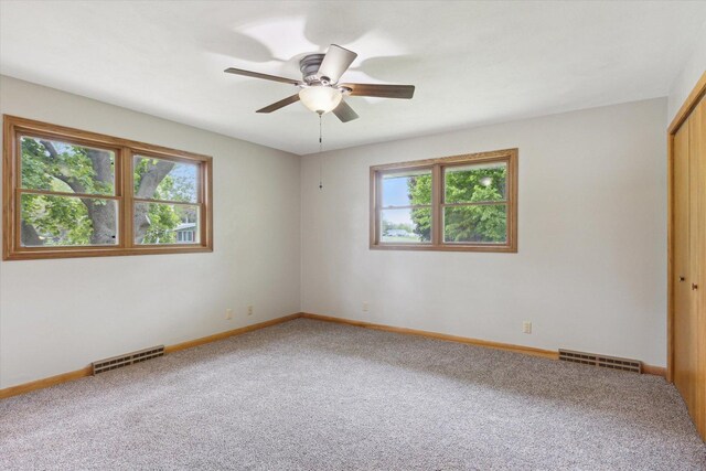 717 S Kennedy St, Shannon, IL 61078 - empty room with healthy amount of natural light, carpet flooring, a ceiling fan, and baseboards