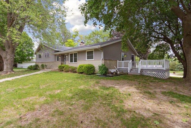 717 S Kennedy St, Shannon, IL 61078 - ranch-style home featuring a chimney, a front yard, and a deck