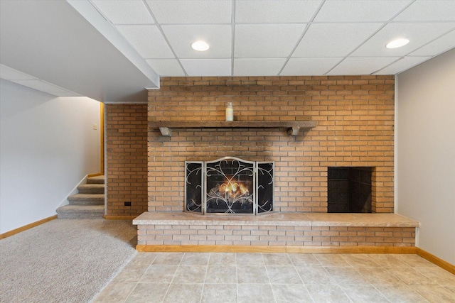 717 S Kennedy St, Shannon, IL 61078 - unfurnished living room with a brick fireplace, a drop ceiling, baseboards, recessed lighting, and stairway