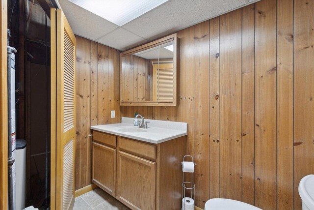 717 S Kennedy St, Shannon, IL 61078 - bathroom with toilet, vanity, wooden walls, and tile patterned flooring