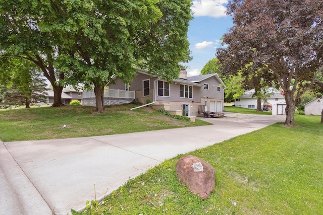 717 S Kennedy St, Shannon, IL 61078 - view of front facade with driveway, a garage, a chimney, and a front yard