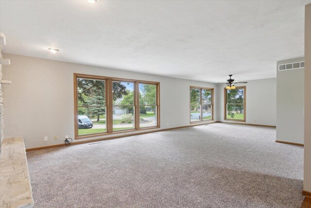 717 S Kennedy St, Shannon, IL 61078 - unfurnished living room featuring healthy amount of natural light, carpet, and baseboards