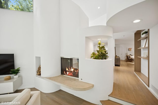 938 Old Green Bay Rd, Winnetka, IL 60093 - hallway with wood finished floors, high vaulted ceiling, and recessed lighting