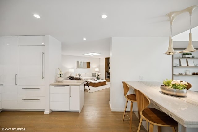 938 Old Green Bay Rd, Winnetka, IL 60093 - kitchen featuring white cabinetry, modern cabinets, baseboards, light wood-type flooring, and light countertops