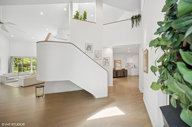 938 Old Green Bay Rd, Winnetka, IL 60093 - living area featuring light wood-style flooring, stairs, a ceiling fan, a high ceiling, and recessed lighting