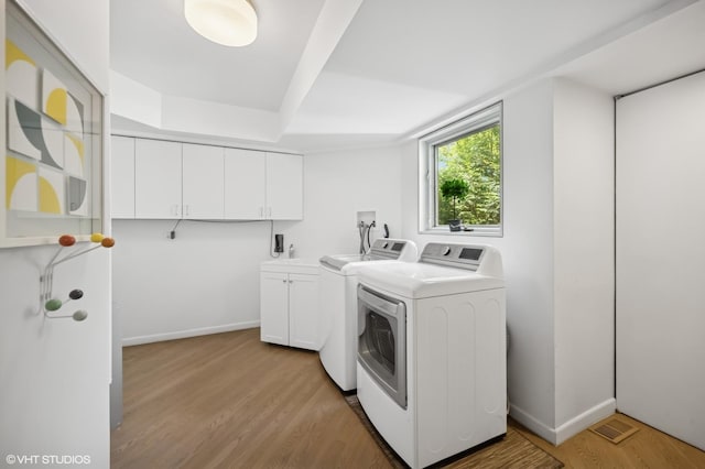 938 Old Green Bay Rd, Winnetka, IL 60093 - washroom featuring washing machine and clothes dryer, cabinet space, light wood-type flooring, and baseboards