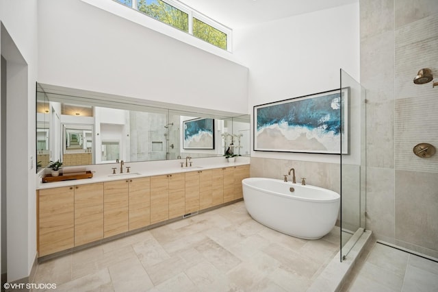 938 Old Green Bay Rd, Winnetka, IL 60093 - full bath with tiled shower, double vanity, a freestanding bath, and a towering ceiling