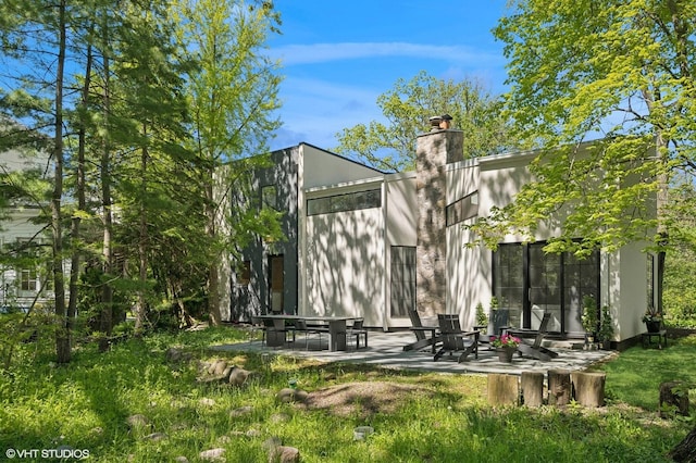 938 Old Green Bay Rd, Winnetka, IL 60093 - back of house with a patio and a chimney