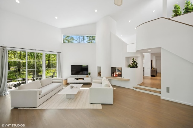 938 Old Green Bay Rd, Winnetka, IL 60093 - living area featuring high vaulted ceiling, healthy amount of natural light, wood finished floors, and recessed lighting