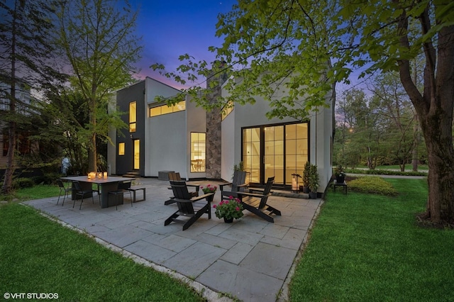 938 Old Green Bay Rd, Winnetka, IL 60093 - back of house with stucco siding, a yard, and a patio area