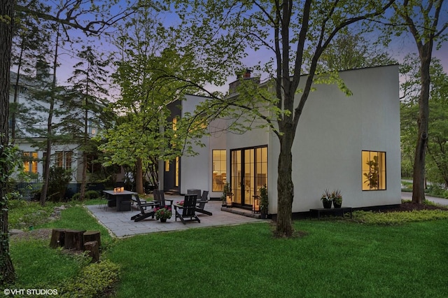 938 Old Green Bay Rd, Winnetka, IL 60093 - back of property featuring a patio area, a fire pit, a lawn, and a chimney