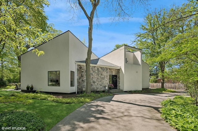 938 Old Green Bay Rd, Winnetka, IL 60093 - contemporary house featuring driveway, stone siding, and stucco siding