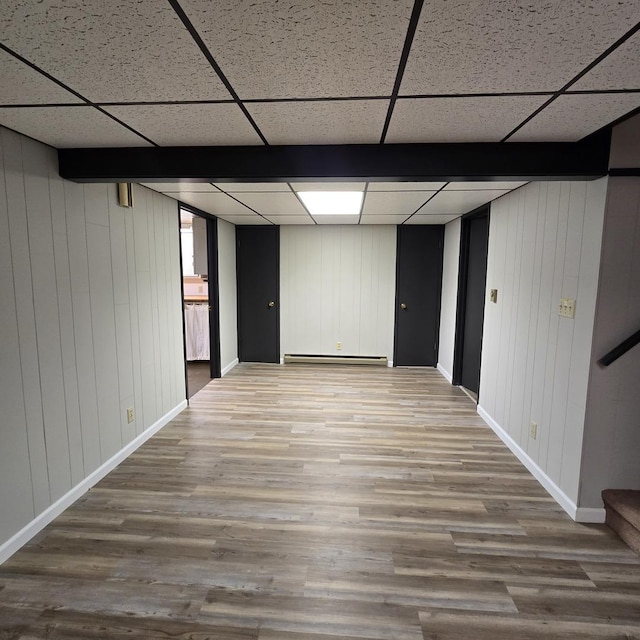 1810 Sylvan Ct, Freeport, IL 61032 - finished below grade area featuring baseboards, a baseboard heating unit, wood finished floors, a paneled ceiling, and stairway