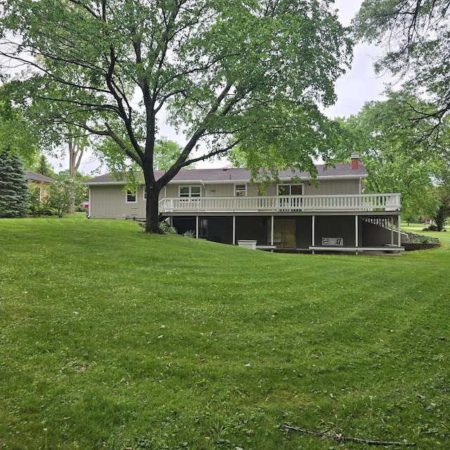 1810 Sylvan Ct, Freeport, IL 61032 - back of house featuring a deck, a lawn, and a chimney