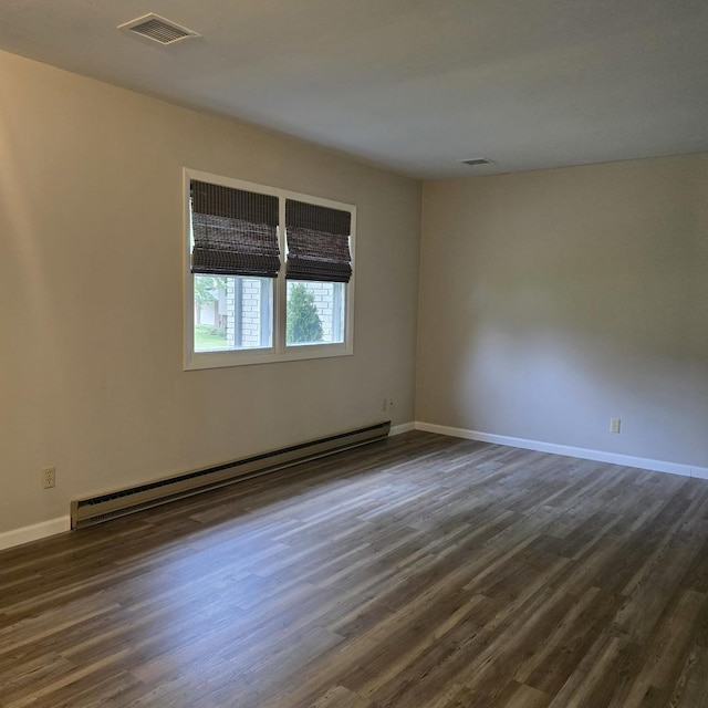 1810 Sylvan Ct, Freeport, IL 61032 - spare room featuring a baseboard heating unit, dark wood-type flooring, and baseboards