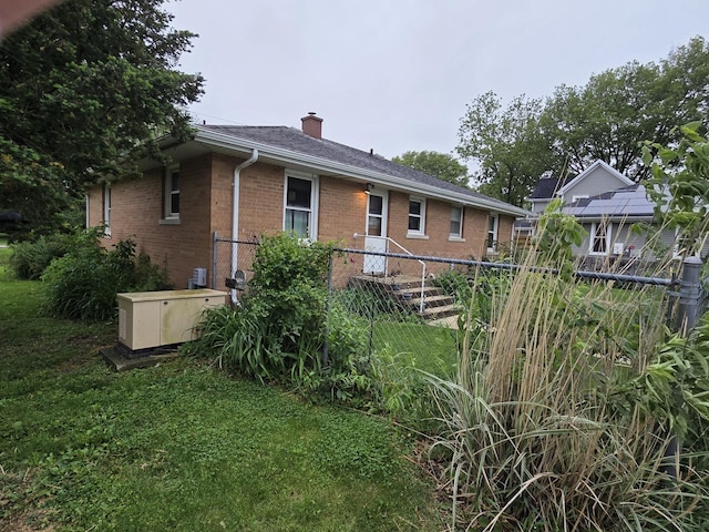 405 W Randolph St, Heyworth, IL 61745 - rear view of house with brick siding and a chimney