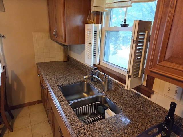 405 W Randolph St, Heyworth, IL 61745 - kitchen with a sink, brown cabinets, tasteful backsplash, and dark stone counters